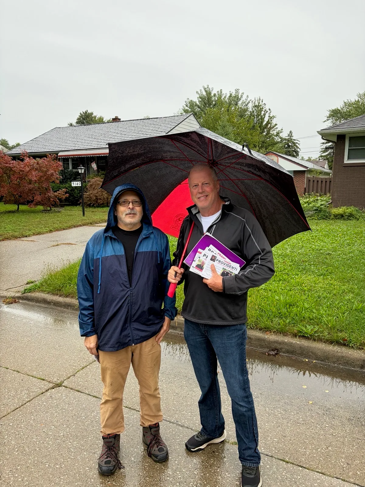 Frank Providenti talking with a resident on a Ward 1 sidewalk