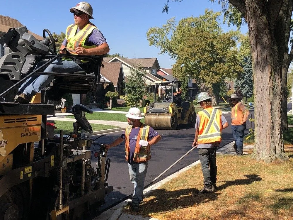 A road crew resurfacing a residential street